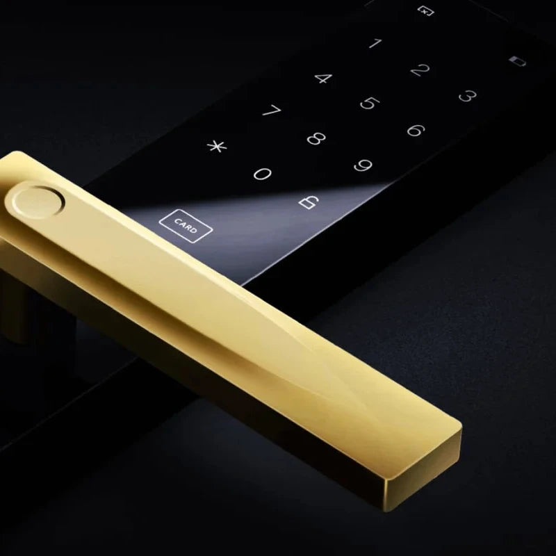 Gold door handle on a black electronic door lock with a dark background